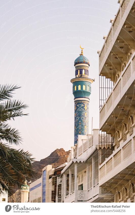 View of minaret with ornaments and mountains in the background Oman Nutmeg Town Arabian Peninsula houses oriental Architecture Building style Tourism