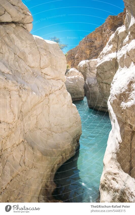 River flows through rocks (Wadi in Oman) Nature Sand Dry Vacation & Travel clear water Water Tourism Swimming & Bathing popular Cliff Canyon Sky Colour photo