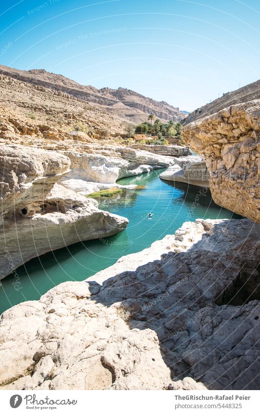 Woman bathing in a clear river flowing between two rocks Wadi Nature Sand Dry Vacation & Travel clear water River Water Tourism Swimming & Bathing popular Oman
