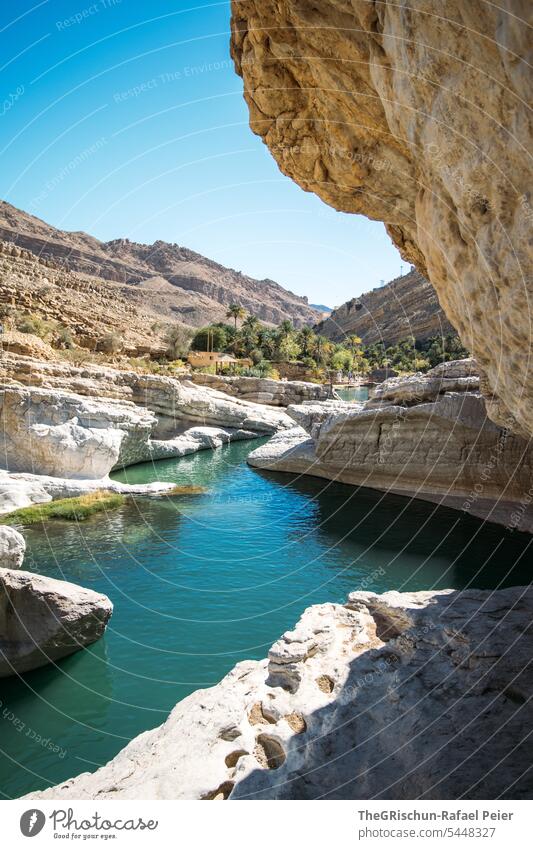 River between rock formations Wadi Nature Sand Dry Vacation & Travel clear water Water Tourism Swimming & Bathing popular Oman Cliff Canyon Sky Colour photo