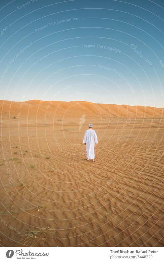 Man with traditional Omani suit walks in the desert Sand Exterior shot Colour photo Nature Tourism Wahiba Sands Omani desert Landscape Desert Vacation & Travel