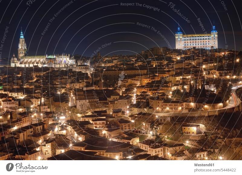 Spain, Toledo, view to lighted cityscape with cathedral and Alcazar in the background at night by night nite night photography World Cultural Heritage