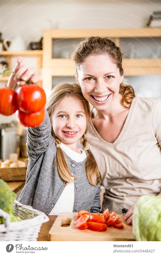 Mother and daughter preparing salad in kitchen domestic kitchen kitchens Tomato Tomatoes mother mommy mothers mummy mama daughters Vegetable Vegetables Food