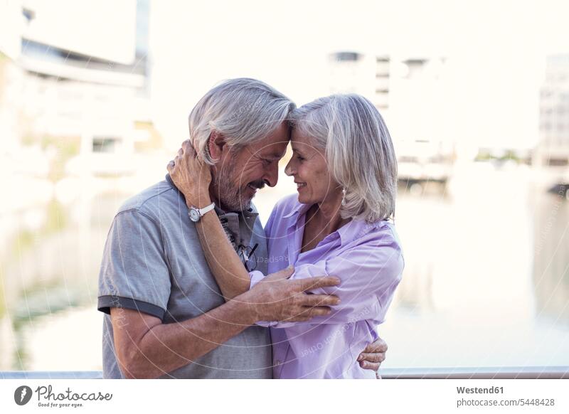 Senior couple taking a city break, kissing and embracing kisses on the move on the way on the go on the road City Break City Trip Urban Tourism happiness happy