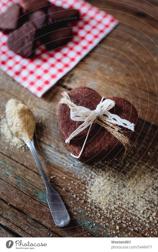 Stack of heart-shaped chocolate shortbreads tied with lace and tea spoon of brown sugar on wood food and drink Nutrition Alimentation Food and Drinks Lace lacey