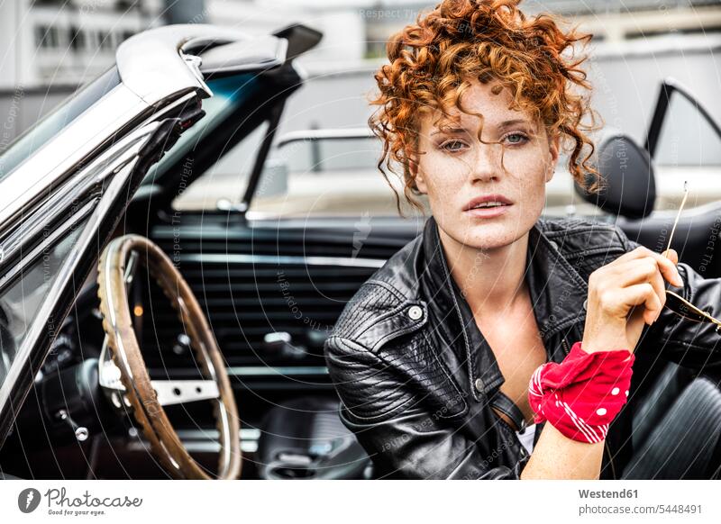 Portrait of confident redheaded woman in sports car portrait portraits automobile Auto cars motorcars Automobiles females women motor vehicle road vehicle