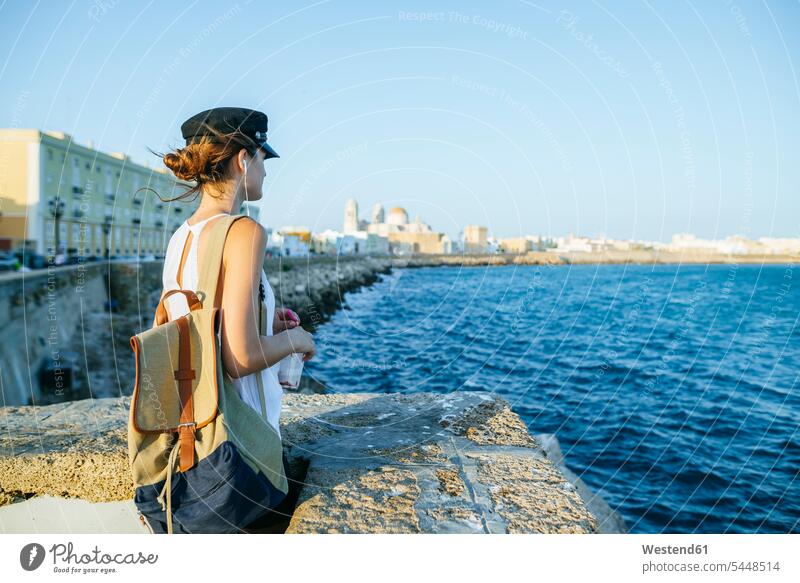 Spain, Andalusia, Cadiz, young woman looking at the sea standing ocean females women water waters body of water Adults grown-ups grownups adult people persons