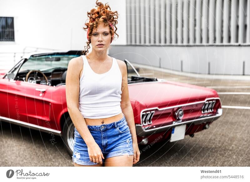 Portrait of redheaded woman at sports car females women automobile Auto cars motorcars Automobiles portrait portraits Adults grown-ups grownups adult people
