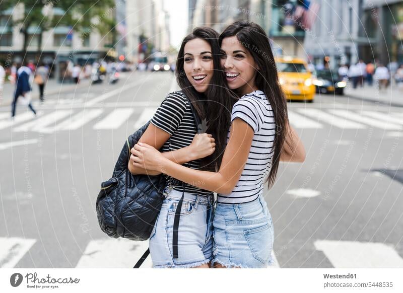 USA, New York City, two happy twin sisters in Manhattan New York State Fun having fun funny female friends siblings brother and sister brothers and sisters