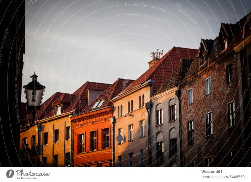 Poland, Torun, row of houses at the old town at sunset outdoors outdoor shots location shot location shots Architecture city city center downtown city centre