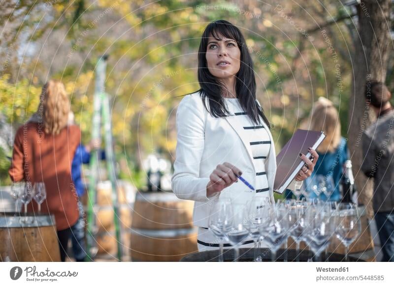 Saleswoman at wine selling event preparing wine station expertise expert knowledge know-how analytic expertise know how stand stands stall stalls marketing