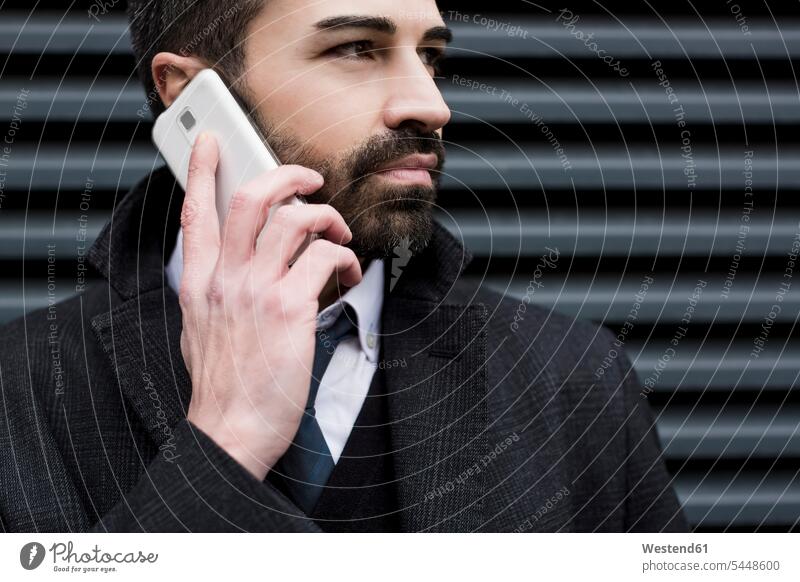 Close-up of businessman on cell phone mobile phone mobiles mobile phones Cellphone cell phones Businessman Business man Businessmen Business men on the phone