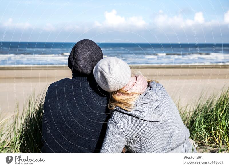 Couple sitting in dunes beach beaches relaxed relaxation couple twosomes partnership couples Seated sand dune sand dunes relaxing people persons human being