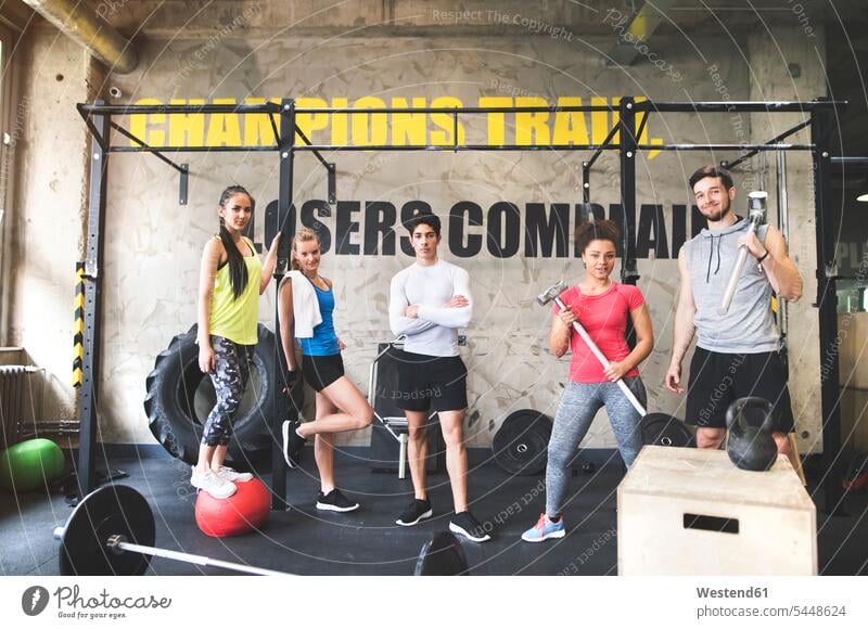 Portrait of confident young people posing in gym smiling smile portrait portraits exercising exercise training practising fitness Fitness training gyms