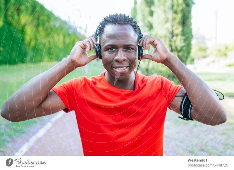 Portrait of man in sportswear listening music with headphones men males headset portrait portraits Adults grown-ups grownups adult people persons human being