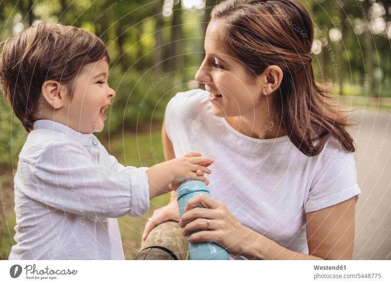 Mother and her little son having fun together in a park mother mommy mothers ma mummy mama boy boys males parents family families people persons human being