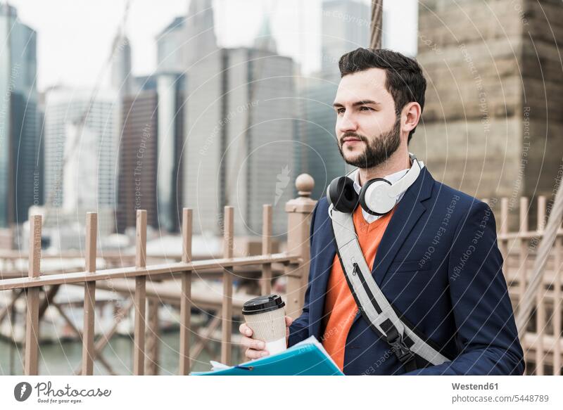 USA, New York City, man on Brooklyn Bridge with takeaway coffee Coffee New York State men males bridge bridges Drink beverages Drinks Beverage food and drink