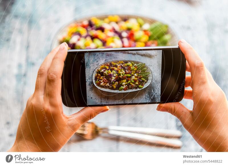Girl taking picture of Quinoa salad with smartphone, close-up photographing hand human hand hands human hands people persons human being humans human beings