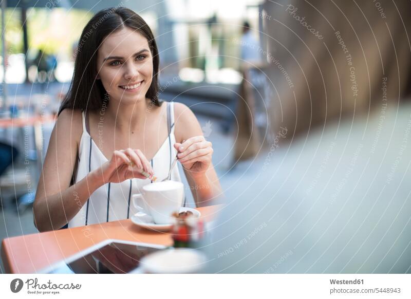 Smiling woman looking at friend at an outdoor cafe female friends happiness happy mate friendship Selective focus Differential Focus relaxation relaxed relaxing