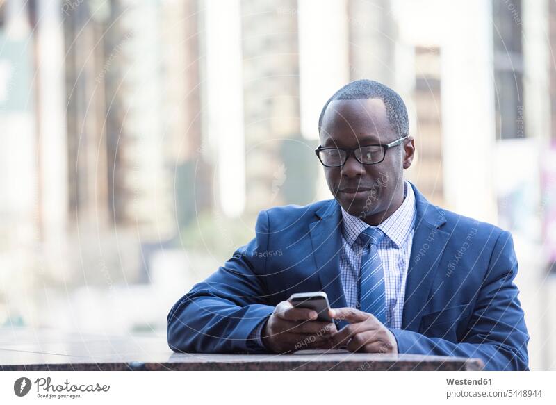 Businessman checking cell phone outdoors mobile phone mobiles mobile phones Cellphone cell phones portrait portraits Business man Businessmen Business men