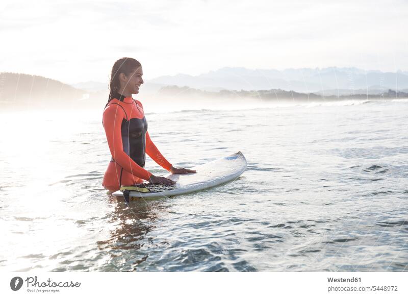 Female surfer in the water surfboard surfboards female surfer surfers female surfers sea ocean woman females women surfing surf ride surf riding Surfboarding