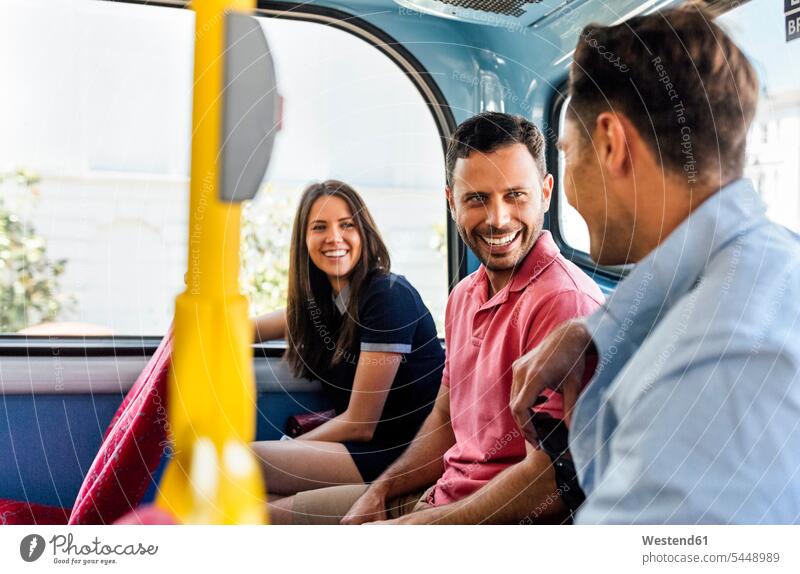UK, London, three friends sitting in a double decker bus talking portrait portraits busses friendship motor vehicle road vehicle road vehicles motor vehicles