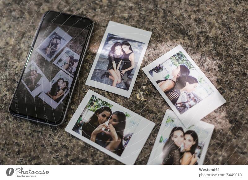 Instant photos of twin sisters mobile phone mobiles mobile phones Cellphone cell phone cell phones female friends photograph photographs mate friendship image