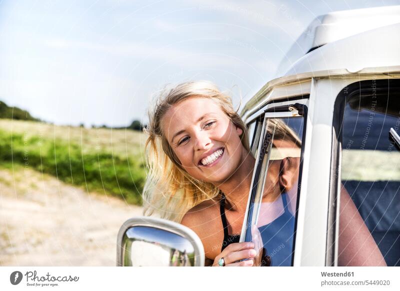Happy woman looking out of window of a van rural country countryside Fun having fun funny laughing Laughter females women motor vehicle road vehicle