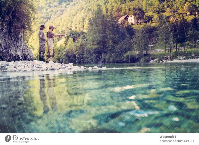 Slovenia, two men fly fishing in Soca river man males River Rivers standing angler anglers angling fly-fishing Adults grown-ups grownups adult people persons