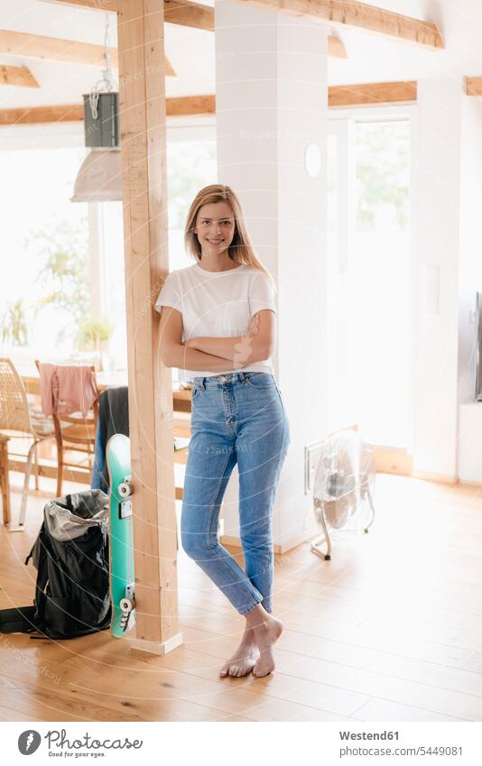 Confident young woman standing in her apartment with arms crossed carefree confidence confident timber timbers home ownership private owned home smiling smile