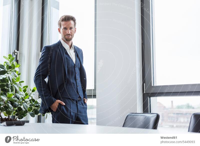 Portrait of businessman standing in his office Businessman Business man Businessmen Business men offices office room office rooms business people businesspeople