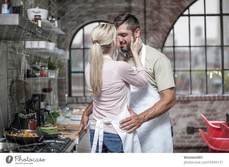 Loving couple preparing food in kitchen cooking twosomes partnership couples people persons human being humans human beings Joy enjoyment pleasure Pleasant