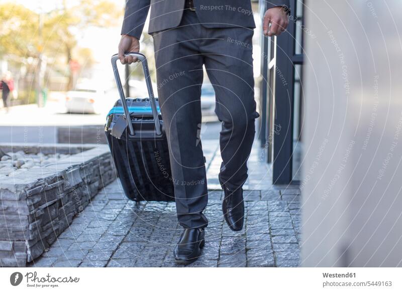 Businessman walking with luggage going baggage Business man Businessmen Business men business people businesspeople business world business life commuter