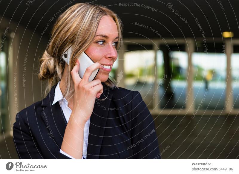 Portrait of smiling businesswoman on the phone businesswomen business woman business women portrait portraits call telephoning On The Telephone calling
