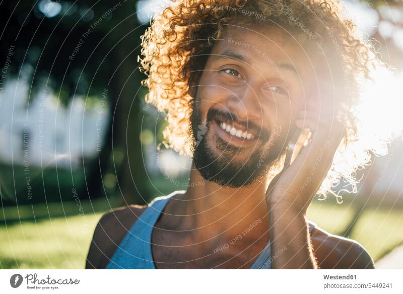 Portrait of smiling young man on cell phone smile men males mobile phone mobiles mobile phones Cellphone cell phones on the phone call telephoning