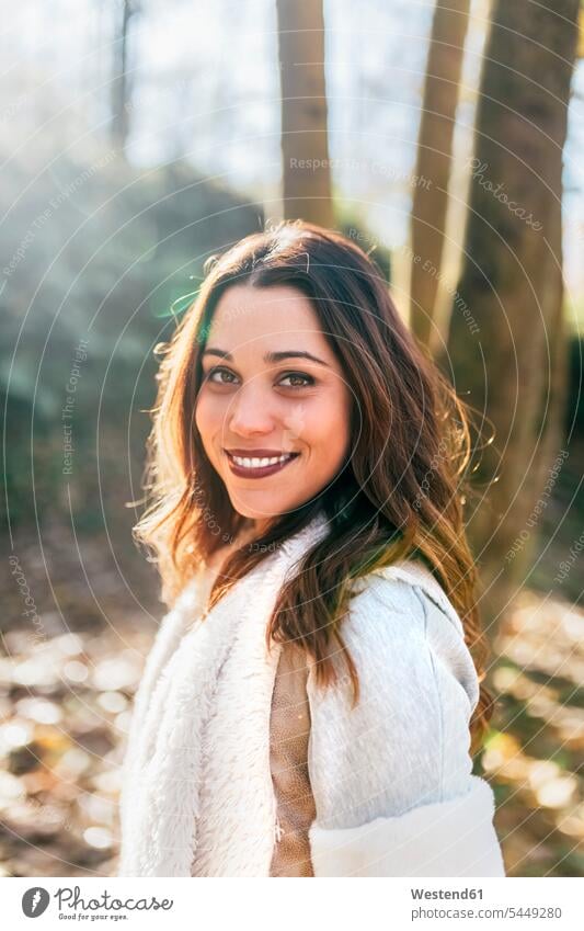 Portrait of a beautiful smiling woman in an autumnal forest fall portrait portraits females women woods forests smile Adults grown-ups grownups adult people