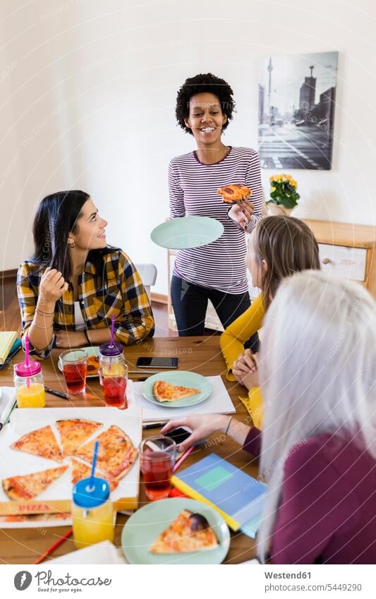 Group of young women at home studying and having pizza student female students Pizza Pizzas woman females education Food foods food and drink Nutrition