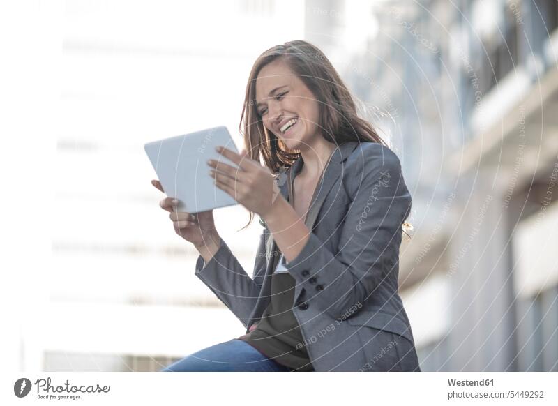 Young laughing woman using digital tablet caucasian caucasian ethnicity caucasian appearance european Wifi Wi-Fi wireless internet WLan wireless lan W-Lan