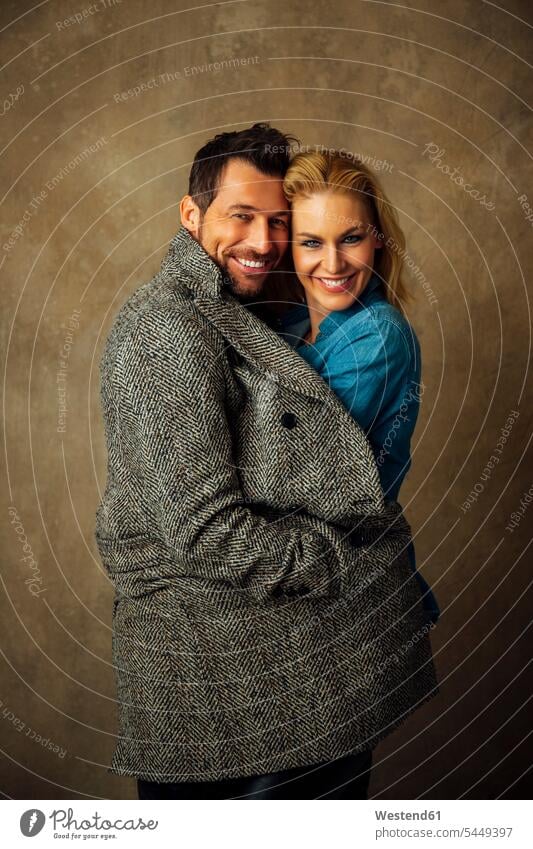 Portrait of happy couple smiling smile twosomes partnership couples portrait portraits people persons human being humans human beings standing Brown Background