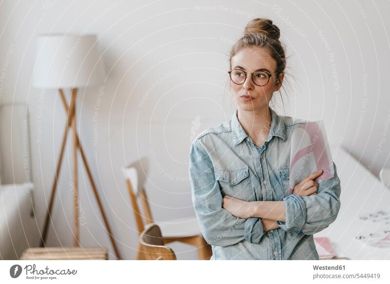 Young woman holding letter template looking sideways females women working At Work Adults grown-ups grownups adult people persons human being humans