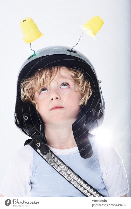 Portrait of a boy dressed up as spaceman playing boys males astronaut astronauts helmet helmets Protective Headwear child children kid kids people persons