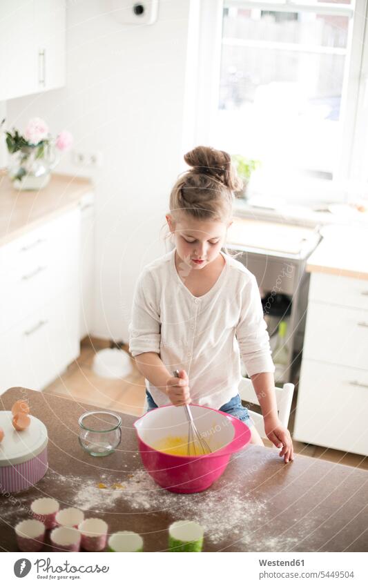 Little girl baking in the kitchen females girls bake child children kid kids people persons human being humans human beings standing stirring learning Table