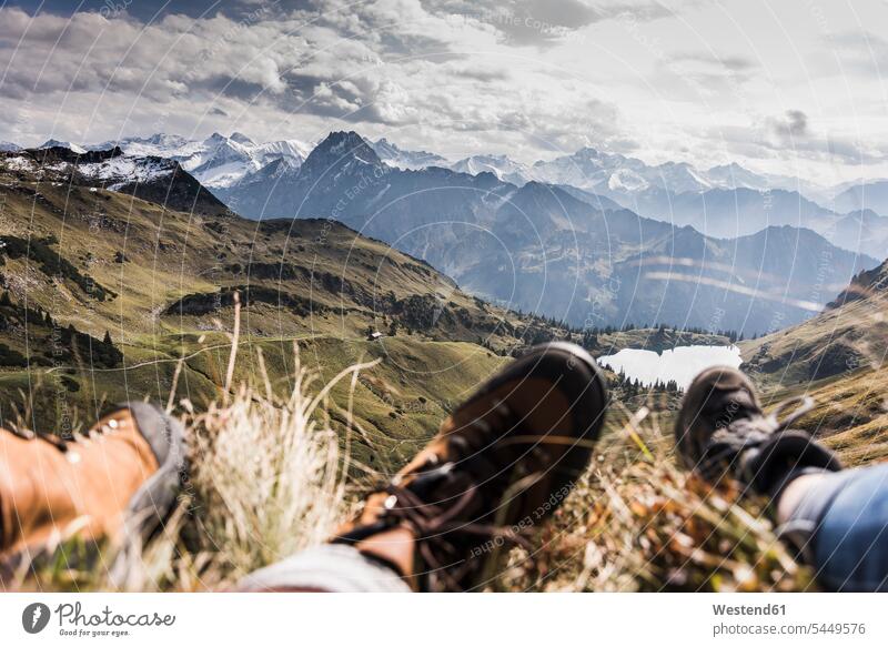 Germany, Bavaria, Oberstdorf, feet of two hikers resting in alpine scenery mountain range mountains mountain ranges hiking couple twosomes partnership couples