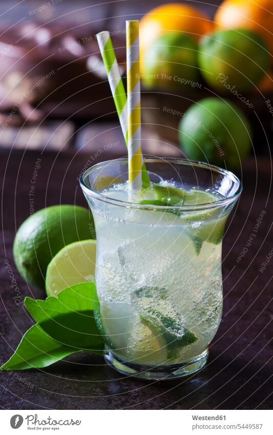 Fruit spritzer of limes in a glass with drinking straws Glass Drinking Glasses studio shot studio shots studio photograph studio photographs healthy eating