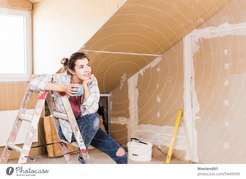 Young woman contemplating the renovation of her new home DIY Doityourself Do it yourself Do-it-yourself young women young woman ladder ladders home ownership