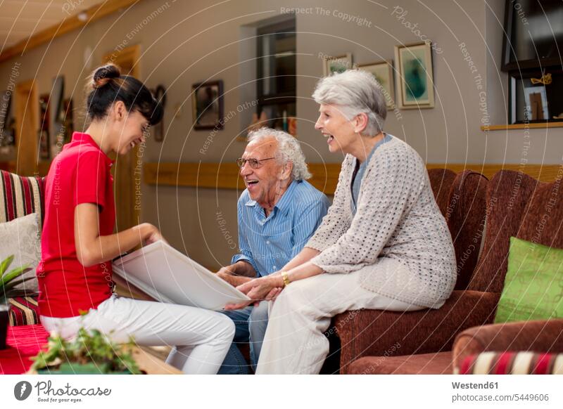 Nurse teaching seniors in retirement home, how to use laptop photograph photographs photos sharing share nursing home Memory memories geriatric nurse