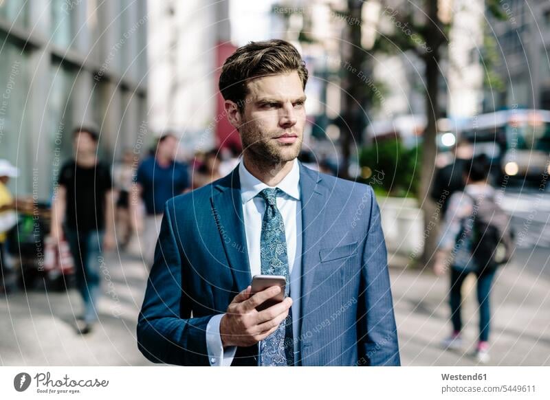 Handsome businessman walking in Manhattan, using mobile phone attractive beautiful pretty good-looking Attractiveness going mobiles mobile phones Cellphone