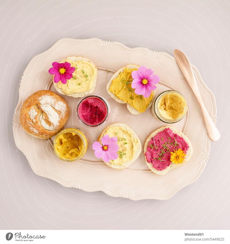 Bread rolls with vegan spreads and edible flowers Curry variation Snack Snacks Snack Food spreading Hummus pastel pastels Pastel Colored Slice of Bread
