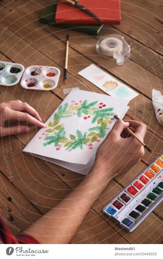 Young woman painting Christmas card with water colors, close-up Christmas cards aquarelle Watercolor Painting hand human hand hands human hands people persons