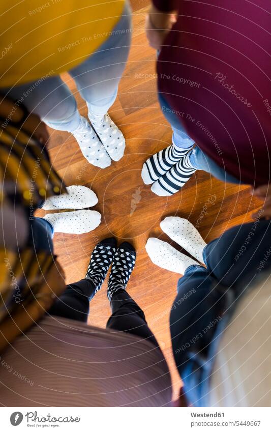 Close-up of feet of five women standing on wooden floor foot human foot human feet woman females wooden floors community Companionship female friends people